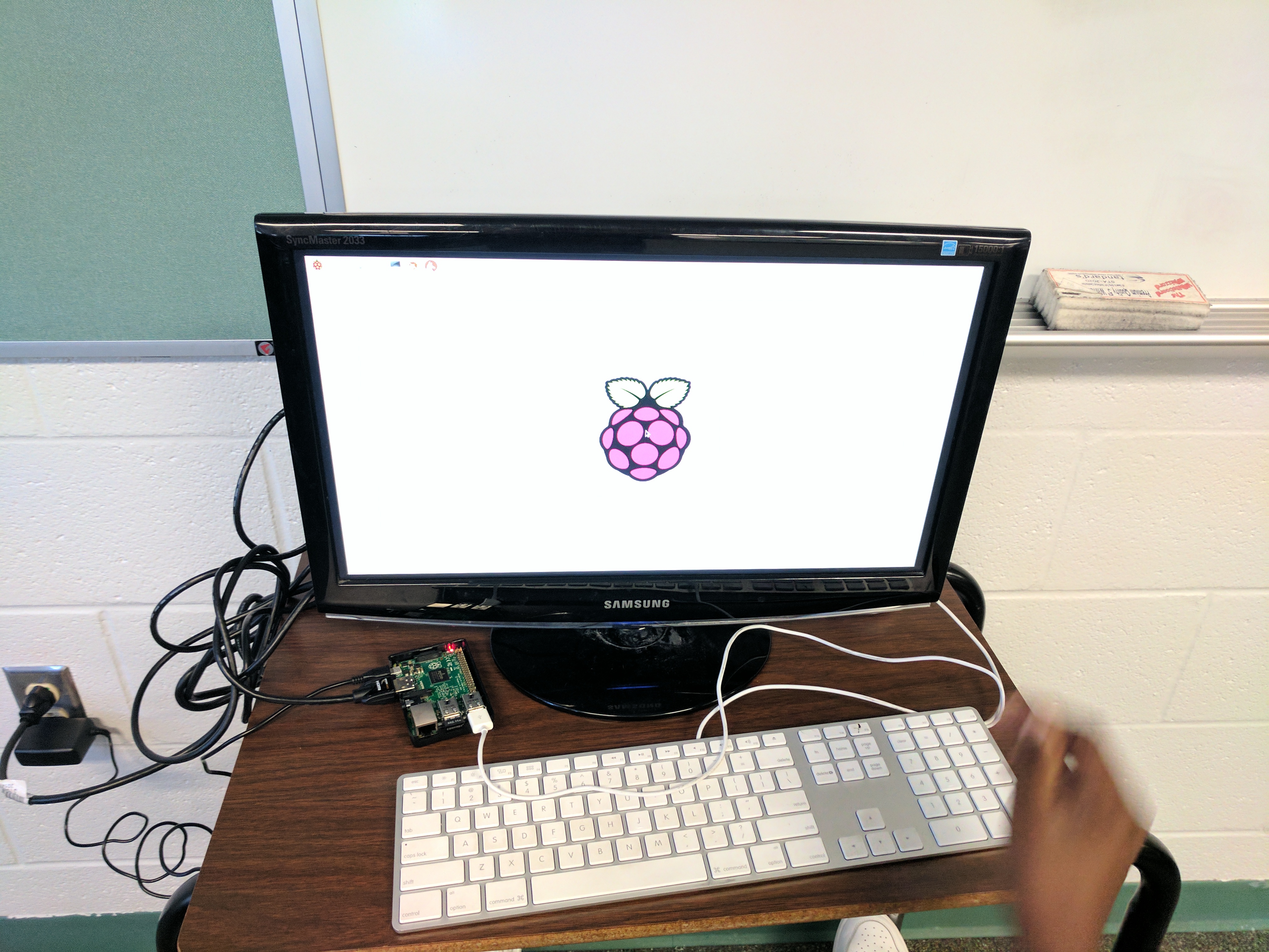 A picture of a computer monitor with the raspberry pi boot-up screen on it